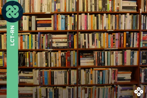 Photograph of books on a bookshelf.