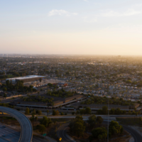 Photograph of Anaheim, CA from the sky with freeways and buildings in the background.