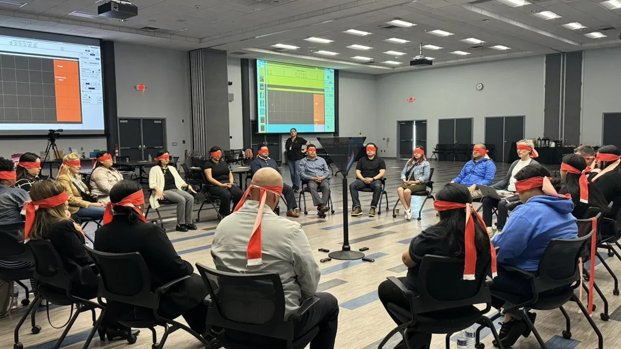 Photograph of people sitting in a circle at a Creative Assembly in Pomona, CA
