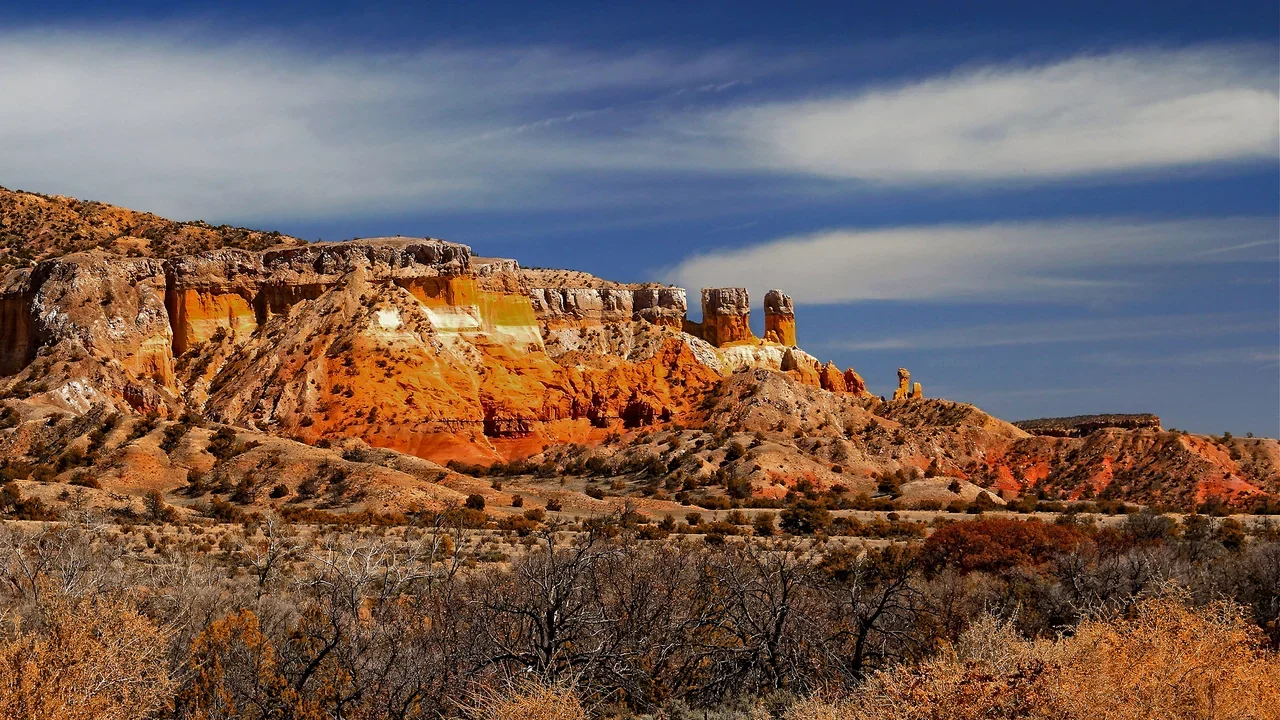 Photograph of New Mexico mountains with blue sky in the background.