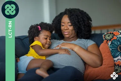 Photograph of pregnant woman and child holding the mom's belly.