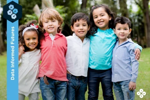 Photograph of five children smiling at the camera