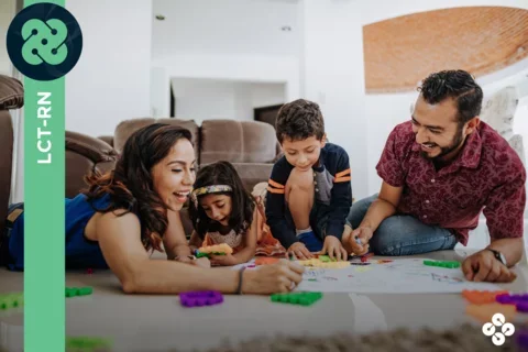 Photograph of a family drawing and playing with kids with green banner reading "LCT-RN" on the left side.