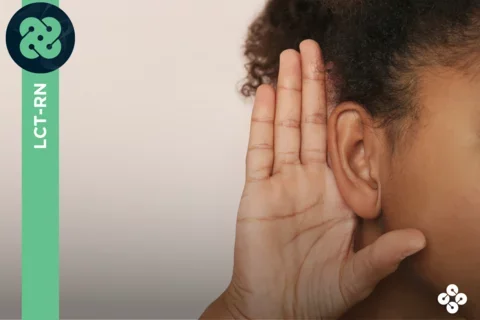 Photograph of person holding their hand to their ear to hear better.