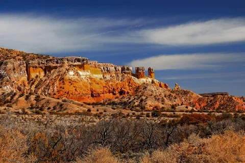 Photograph of New Mexico mountains with blue sky in the background.