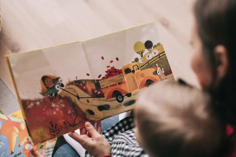 Mother holding her child with a children's picture book