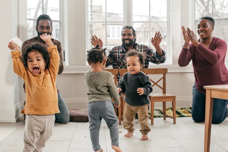 Three parents playing with their children.