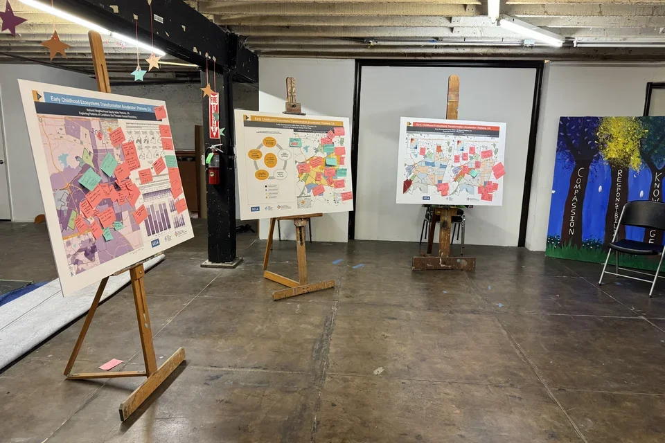 Photograph of three maps that were used in community data chats.