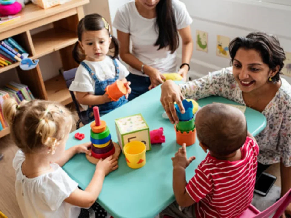 Photograph of toddlers in child care classroom playing with toys