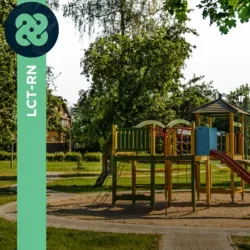 Photograph of an empty playground in a park during midday. 